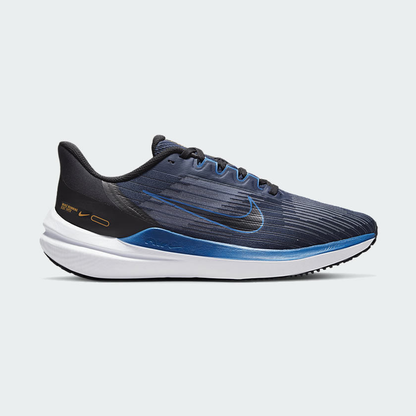 Nike Air Winflo 9 Men's running shoes in dark blue with black accents, side profile showing mesh upper, visible Air unit in the midsole, and Nike Swoosh