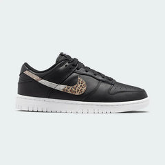 Nike Dunk Low SE Women's trainers in black leather with a white midsole, side profile showing classic silhouette, perforated toe box, and Nike Swoosh.