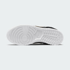 View of the outsole of the Nike Dunk Low SE Women's black leather trainers, showing the durable rubber sole with pivot circles for traction.