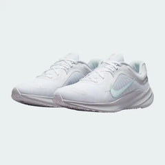 Angled view of two Nike Quest 5 Women's white running shoes, side by side, showcasing their versatile design and cushioned profile.