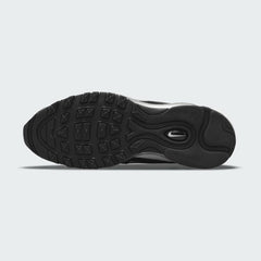 View of the outsole of the Nike Air Max 97 Women's black trainers, showing the durable rubber tread pattern.