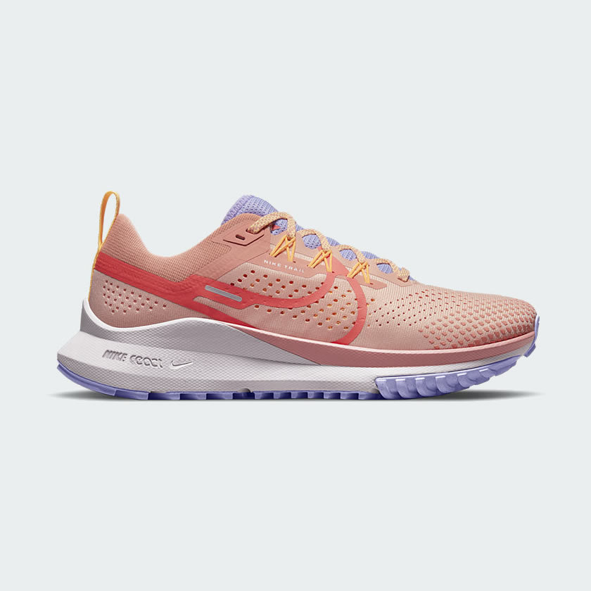 Nike Pegasus Trail 4 Women's running shoes in hot curry orange and pink with black accents, side profile showing engineered mesh upper and rugged rubber outsole.