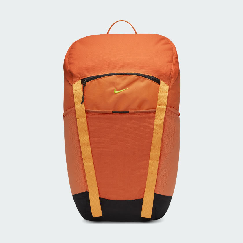 Nike Hike Backpack (27L) in vibrant safety orange, front view showing large main compartment zipper, front zip pocket, and external loops.