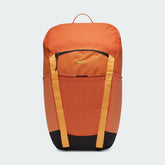 Nike Hike Backpack (27L) in vibrant safety orange, front view showing large main compartment zipper, front zip pocket, and external loops.