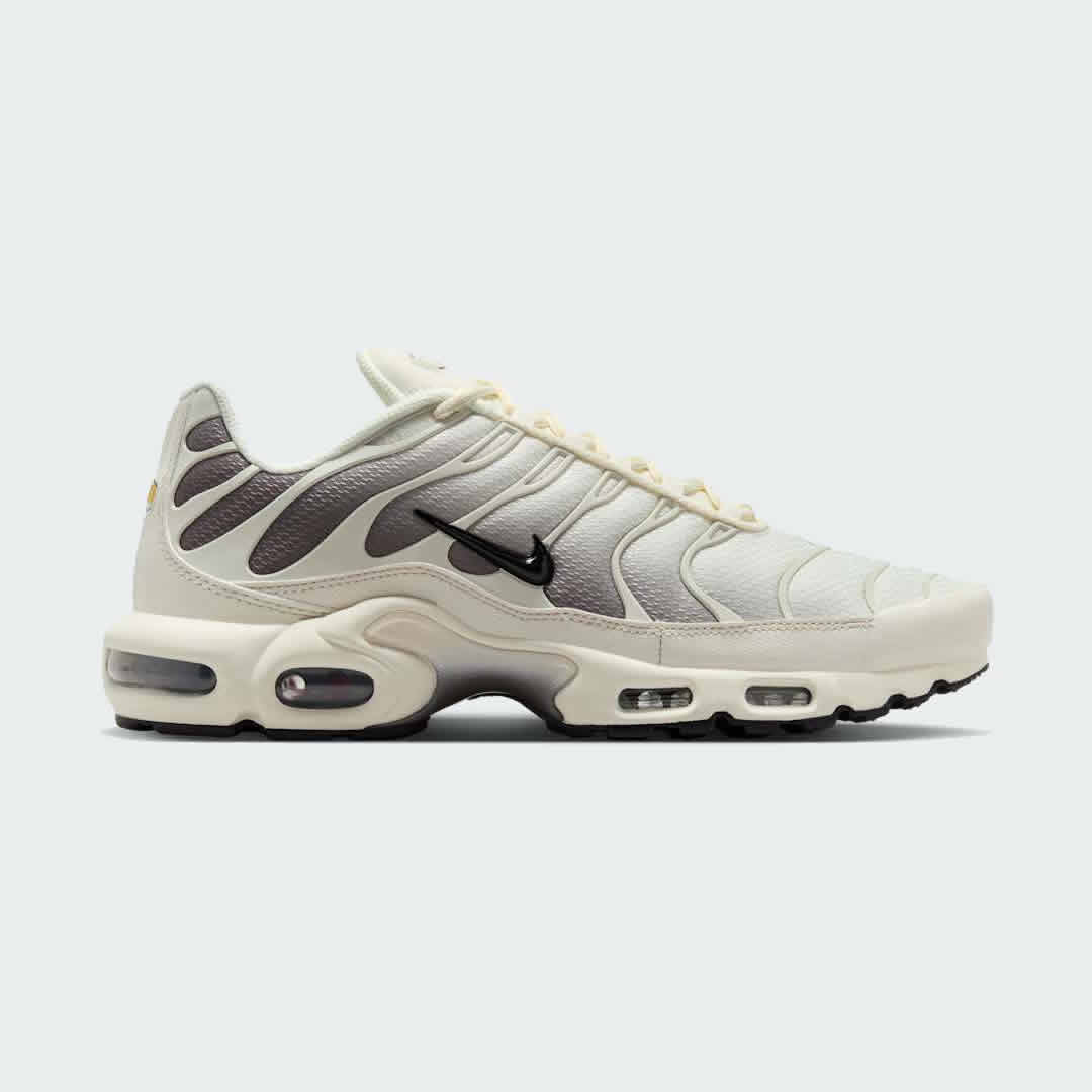 Nike Air Max Plus TN Men's trainers in light orewood brown beige, side profile showing visible Tuned Air units and distinctive wavy overlays.