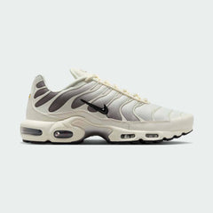 Nike Air Max Plus TN Men's trainers in light orewood brown beige, side profile showing visible Tuned Air units and distinctive wavy overlays.