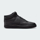 Nike Court Vision Mid Next Nature Men's shoes in all black, side profile showing mid-cut silhouette, classic Nike Swoosh, and durable upper.