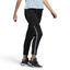 Adidas 7/8 Cropped Snap Pants Women's in black worn by a woman, showcasing the cropped length, side snap details, and relaxed fit in a casual setting.
