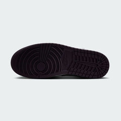 View of the outsole of the Air Jordan 1 Mid Men's black trainers, showing the durable rubber sole in red with pivot circles for traction.