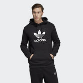 Adidas Trefoil Hoodie Men's in black, model worn front view showing large white Trefoil logo on the chest and a kangaroo pocket.