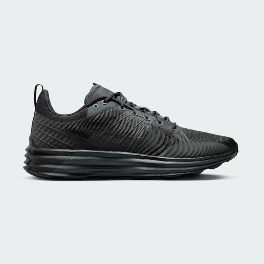 Nike Lunar Roam Men's trainers in dark smoke grey and black, side profile showing plush Lunar foam midsole and breathable textile upper.