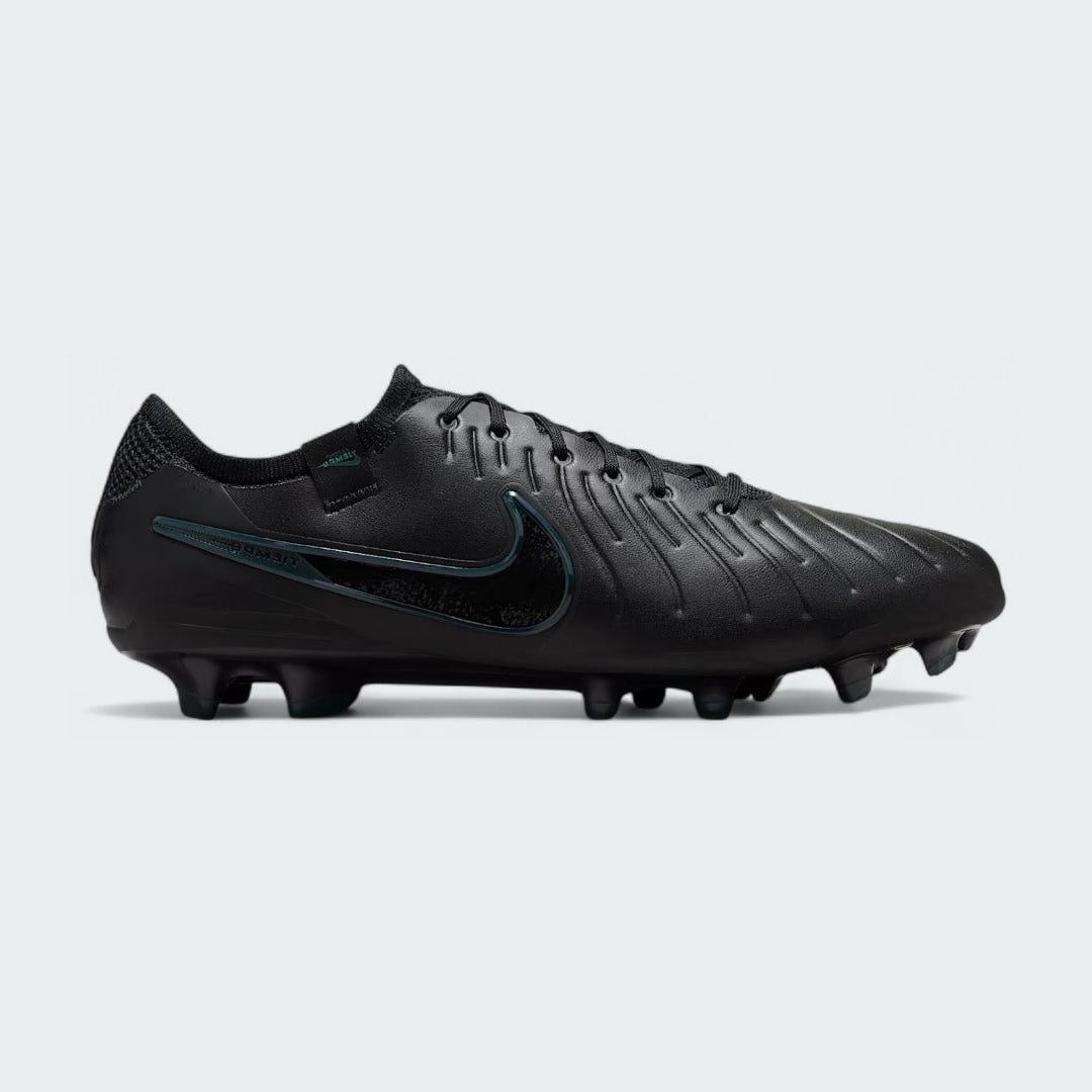 Nike Legend 10 Elite FG men's football boots in black with a deep jungle green Swoosh, side profile showing the FlyTouch Plus upper and firm ground studs.