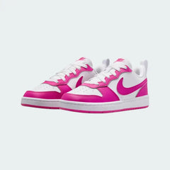 Angled view of two Nike Court Borough Low Recraft Juniors' trainers in white and pink, side by side, showcasing their clean aesthetic and retro style.