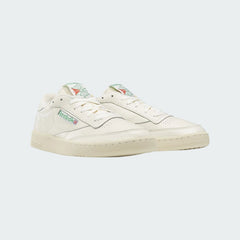 Angled view of two Reebok Classic Club C 85 Vintage trainers in chalk leather, side by side, showcasing their timeless design and pristine off-white colour.