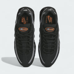 Top-down view of a pair of Nike Air Max 95 Men's running shoes in black, highlighting their iconic silhouette and lacing system.