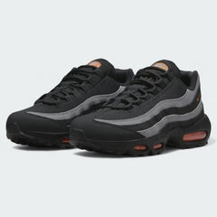 Angled view of two Nike Air Max 95 Men's black running shoes, side by side, showcasing their timeless design and layered upper.