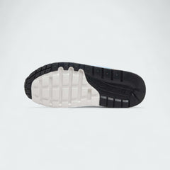 View of the outsole of the Nike Air Max 1 Juniors' brown trainers, showing the durable rubber waffle tread pattern.