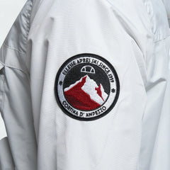 Close-up zoom on the fabric of the Ellesse Mont 2 Overhead Anorak Jacket, showing the textured marl finish and the embroidered or printed Ellesse logo.