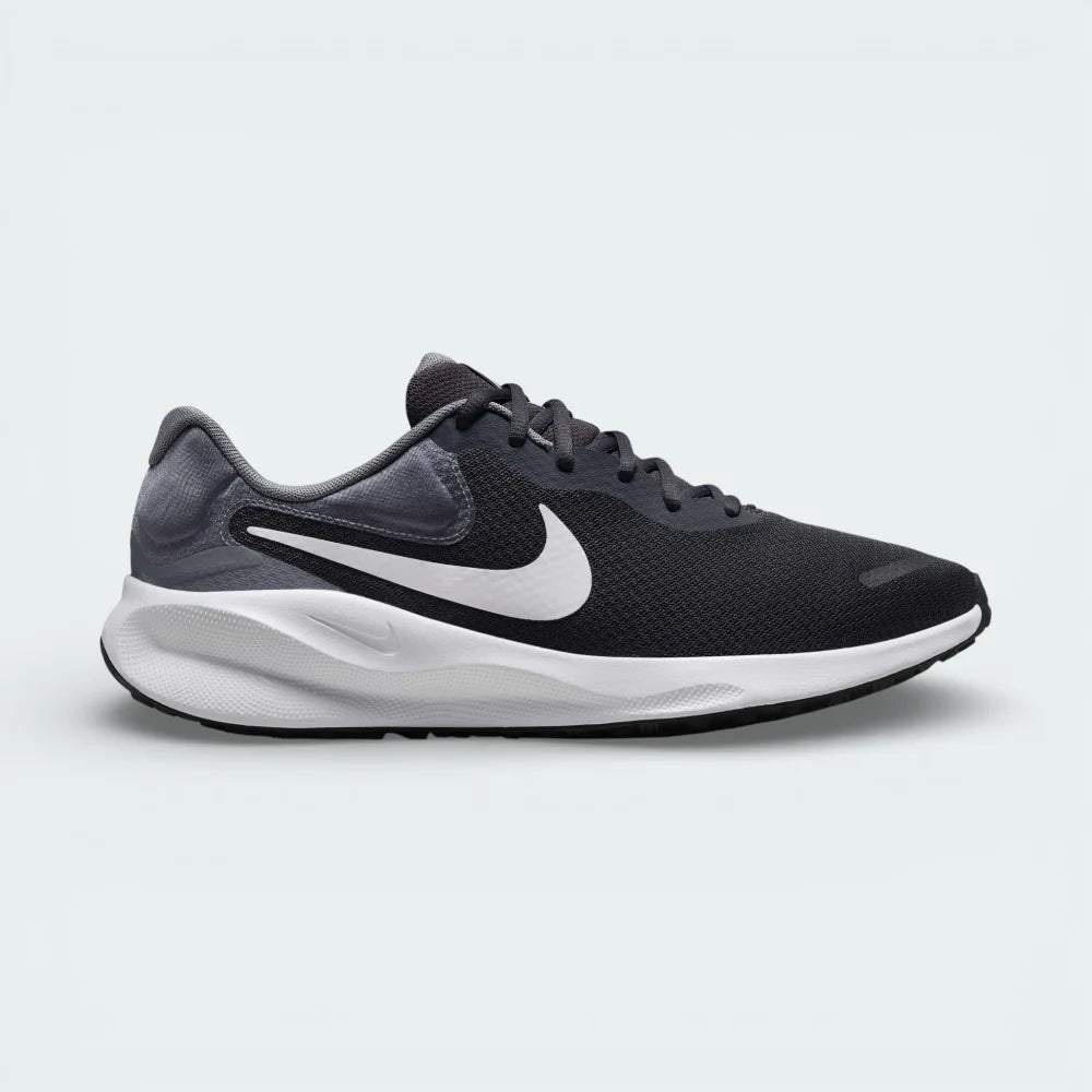 Side profile of the Nike Revolution Men's running shoes in Anthracite grey, showing the white Swoosh, breathable mesh upper, and the clean white midsole.