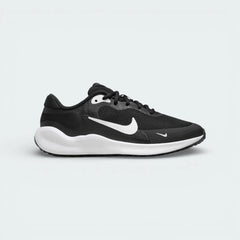 Side profile of the Nike Revolution 7 Juniors in Black, featuring the large white Swoosh and the clean, contoured white foam midsole.