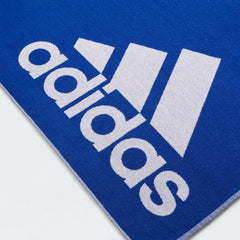 Detailed view of a corner of the Adidas Cotton Towel in royal blue, highlighting the stitched edges and the embroidered white Adidas logo.