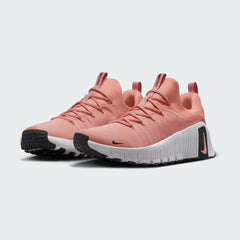 Angled view of two Nike Free Metcon 5 Men's orange and black training shoes, side by side, showcasing their dynamic design and supportive structure.