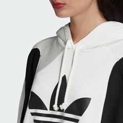 Close-up zoom on the Adidas Women's Oversized Bellista Hoodie in white, showing the soft fleece fabric texture and the embroidered Adidas Trefoil logo detail on the chest.