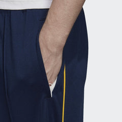 Detailed zoom on the elastic waistband with drawcord or the elastic cuff of the Adidas Recycled Track Pants, highlighting the ribbed texture.