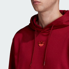 Close-up zoom on the Adidas Outline Overhead Hoodie Men's in red, showing the soft fleece fabric texture and the detailed white Trefoil outline logo.