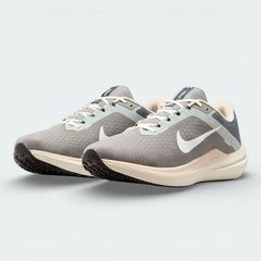 Angled shot of both Nike Winflo 10 trainers side by side, showcasing the clean grey tonal aesthetic and the modern athletic silhouette.