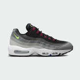 Nike Air Max 95 Next Nature Men's trainers in black with grey and volt accents, side profile showing visible Max Air units in the heel and forefoot, and a layered upper.