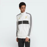 Close-up of the front of the jacket, focusing on the detailed gold embroidery of the Juventus crest and the high-quality zipper.