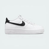 Side profile of the White/Black Nike Air Force 1 Junior, showcasing the bold black Swoosh against the crisp white leather.