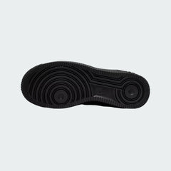 View of the outsole of the Nike Air Force 1 Juniors' black trainers, showing the durable rubber sole with pivot circles for traction.