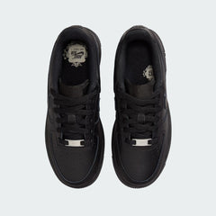 Top-down view of a pair of Nike Air Force 1 Juniors' trainers in black, highlighting the lace-up closure and iconic silhouette.