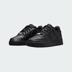 Angled view of two Nike Air Force 1 Juniors' black trainers, side by side, showcasing their timeless design and clean aesthetic.