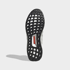 View of the outsole of the Adidas Ultraboost DNA x Lego Men's trainers, showing the durable rubber sole and the Boost cushioning visible through the grid pattern.