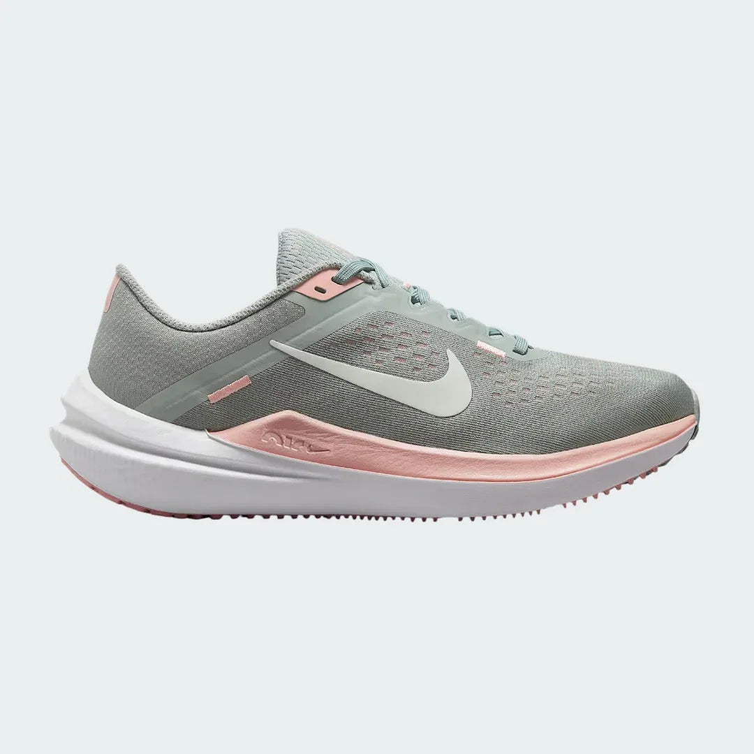 Nike Air Winflo 10 Women's running shoes in green with white accents, side profile showing engineered mesh upper, prominent Nike Swoosh, and cushioned Air midsole.