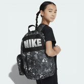 Three-quarter view of the backpack with the pencil case attached, showcasing the front zippered pocket and the iconic Nike Swoosh.