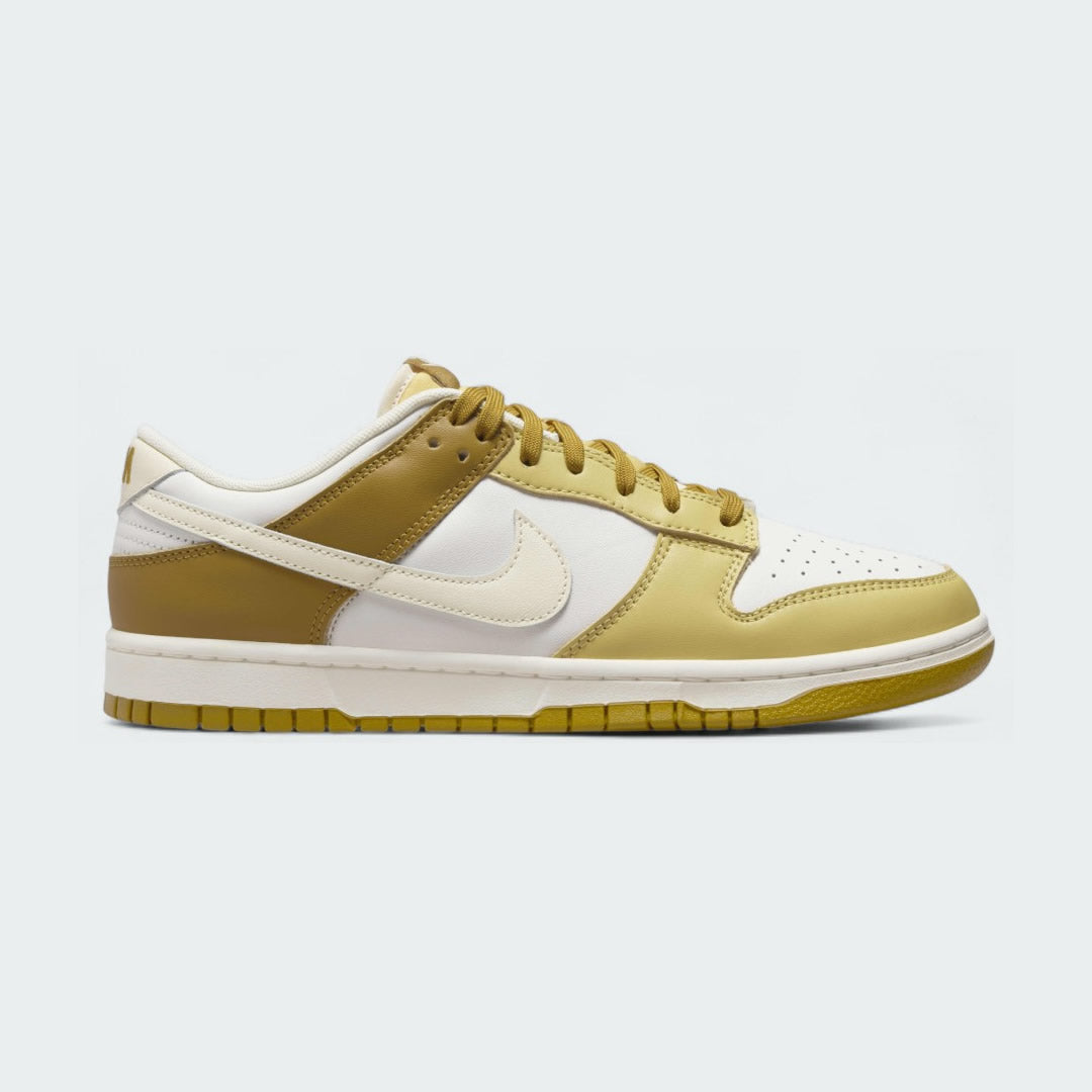 Nike Dunk Low Retro Men's sneakers in bronze leather with off-white accents, side profile showing classic leather upper, Swoosh, and midsole.