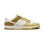 Nike Dunk Low Retro Men's sneakers in bronze leather with off-white accents, side profile showing classic leather upper, Swoosh, and midsole.