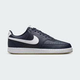 Nike Court Vision Low Men's shoes in obsidian blue leather with a white Nike Swoosh, side profile showing classic basketball-inspired design and low-cut collar.