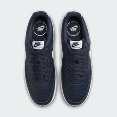 Top-down view of a pair of Nike Court Vision Low Men's shoes in blue, highlighting the lace-up closure and perforated toe box.