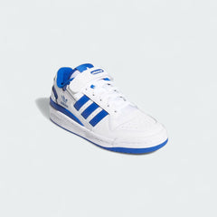 Angled view of Adidas Forum Low Juniors' trainers in white with royal blue accents, on its side, showcasing their iconic design and clean aesthetic.