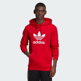 Adidas Trefoil Hoodie Overhead Men's in red, front view showing large white Trefoil logo on the chest and a kangaroo pocket.