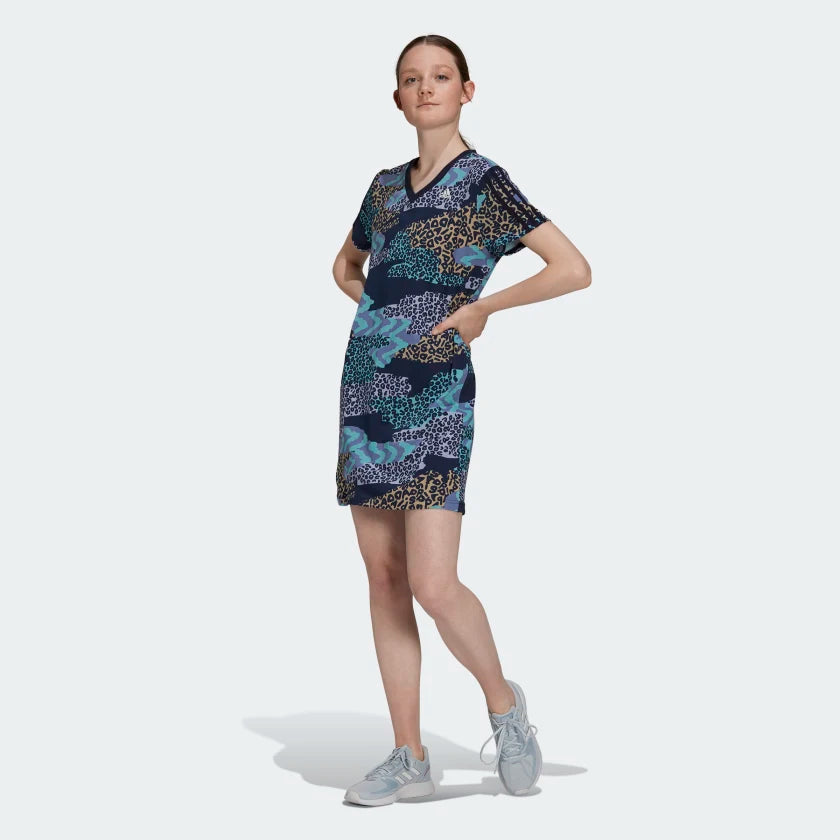 Adidas x Farm Rio 3 Stripe women's all over print dress in navy worn by a woman, showcasing the comfortable fit and vibrant style.
