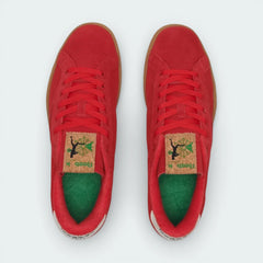 Top-down view of the red and green Reebok trainers, highlighting the soft suede texture and the matching red lacing system.