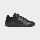 Adidas Forum Low Men's trainers in core black leather, side profile showing classic silhouette, tonal Three Stripes, and hook-and-loop ankle strap.