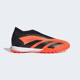 Adidas Predator Accuracy.3 Laceless Turf Boots in solar orange and black, side profile showing the textured synthetic upper, mid-cut collar, and rubber turf sole.