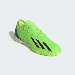 Angled view of two Adidas X Speedportal.3 Indoor Men's green boots, side by side, showcasing their vibrant design and lightweight construction.